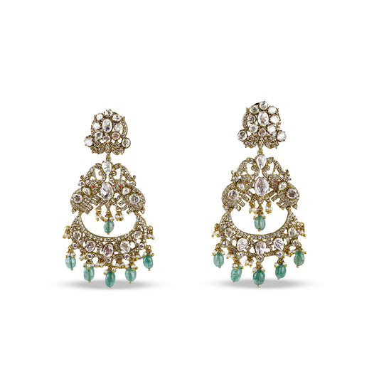 Pair of antique-finish kundan chandelier earrings with white stones, layered detailing, and green bead drops – handcrafted heritage jewellery by Atelier Maharanibagh.